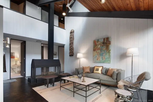 a living room with furniture a large window with outer view