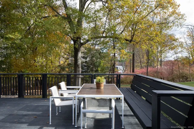 a view of a swimming pool with lawn chairs under an umbrella