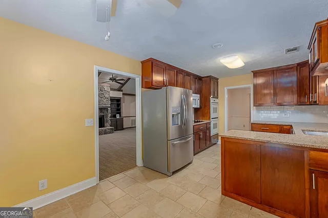 a kitchen with stainless steel appliances a refrigerator and a stove