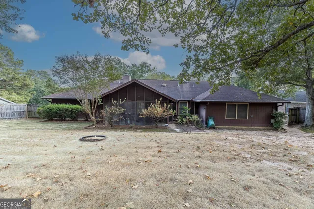 a backyard of a house with table and chairs