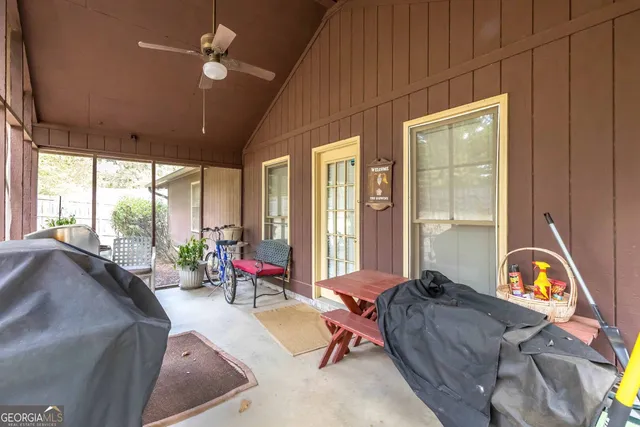 a living room with furniture a window and gym equipment