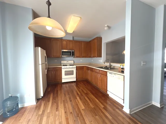 a kitchen with cabinets a sink and appliances