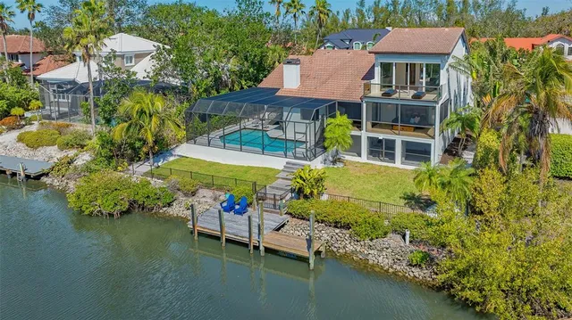 an aerial view of a house with swimming pool and outdoor space