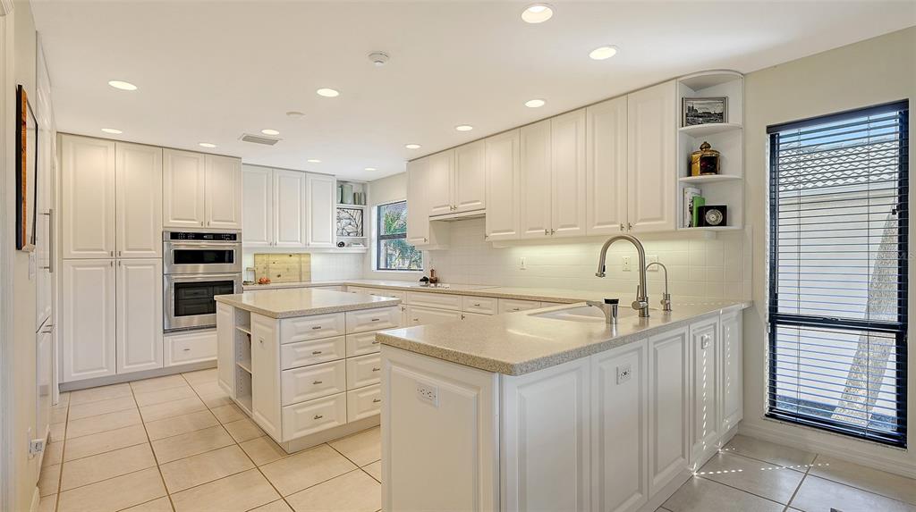 3151 Bayou Sound Longboat Key, FL 34228 - Photo 16 of 68 a kitchen with stainless steel appliances granite countertop a sink and cabinets