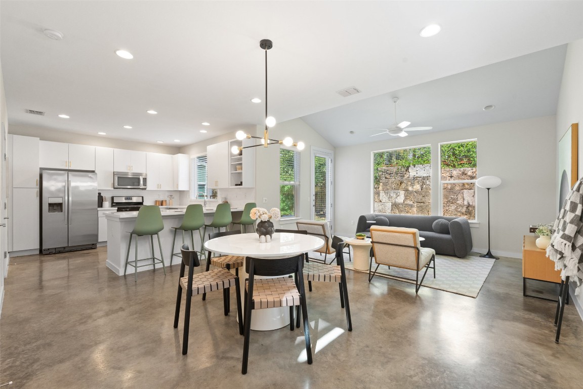 3001 Del Curto Road, Unit 11 Austin, TX 78704 - Photo 1 of 1 Dining area featuring a chandelier, finished concrete floors, recessed lighting, lofted ceiling, and plenty of natural light