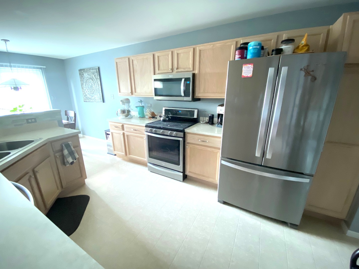 25734 Bridle Path Channahon, IL 60410 - Photo 11 of 29 a kitchen with stainless steel appliances granite countertop a refrigerator a stove a sink and a microwave