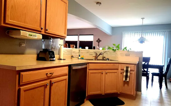 a kitchen with stainless steel appliances granite countertop a refrigerator a stove a sink and a microwave