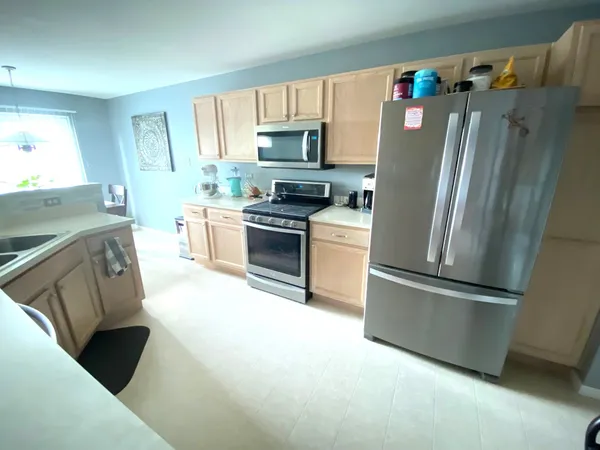 a kitchen with a sink a stove and cabinets