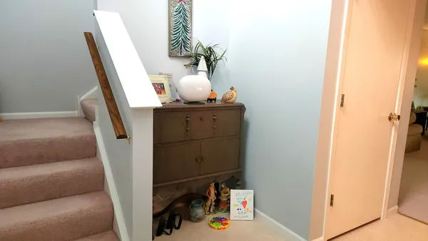 a view of hallway with stairs and wooden floor