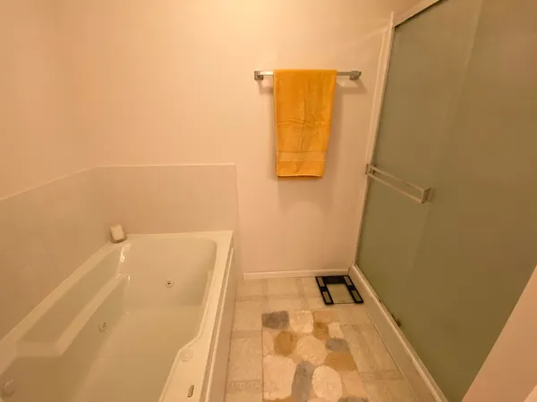 a bathroom with a sink tub and a mirror