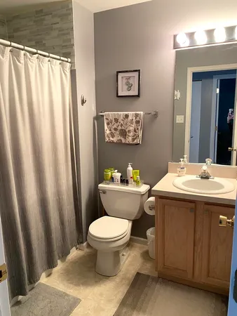 a bedroom with furniture and a flat screen tv