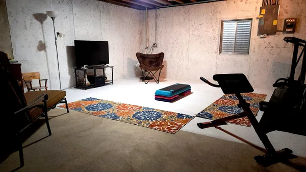 a backyard of a house with table and chairs