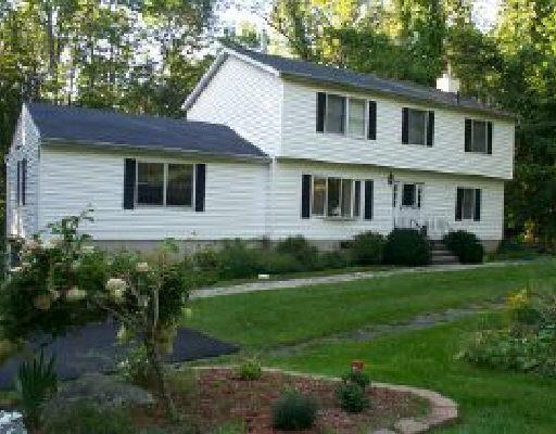 91 Bridle Trail Ridgefield, CT 06877 - Photo 1 of 1 a front view of a house with garden