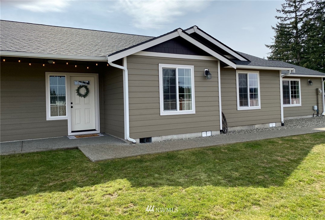 9235 179th Trail Southwest Rochester, WA 98579 - Photo 1 of 38 a front view of a house with a yard