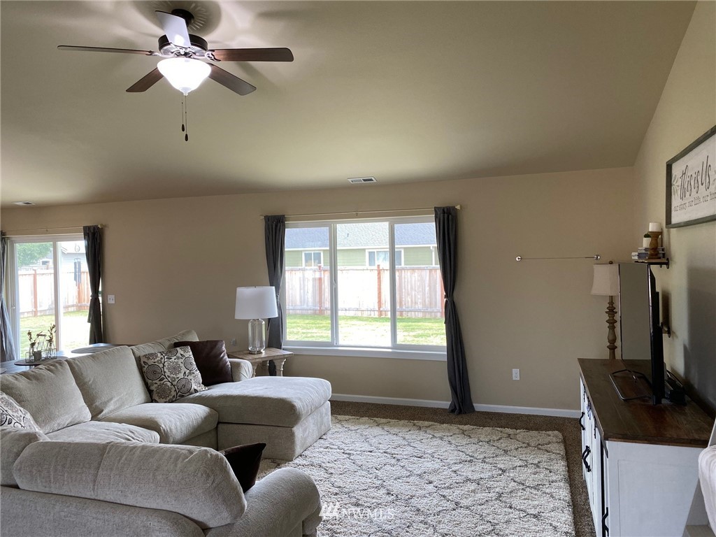 9235 179th Trail Southwest Rochester, WA 98579 - Photo 14 of 38 a living room with furniture a window and a flat screen tv