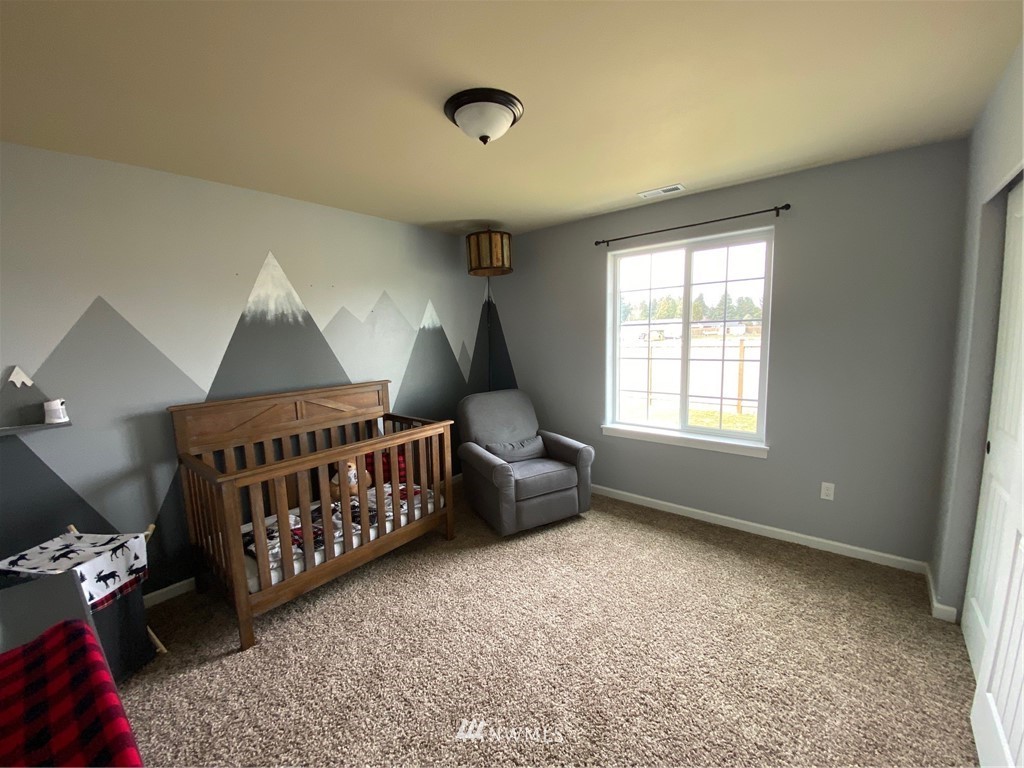 9235 179th Trail Southwest Rochester, WA 98579 - Photo 22 of 38 a bedroom with furniture and a window