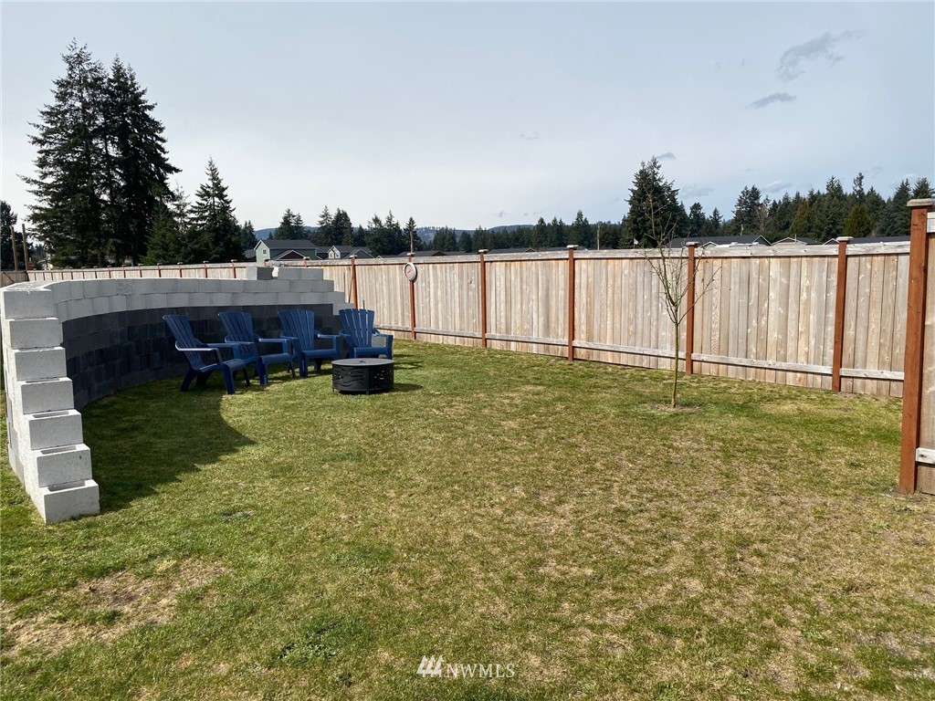 9235 179th Trail Southwest Rochester, WA 98579 - Photo 30 of 38 a backyard of a house with lots of green space