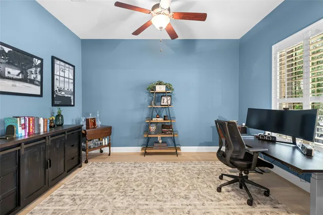 a view of a workspace with furniture and a window