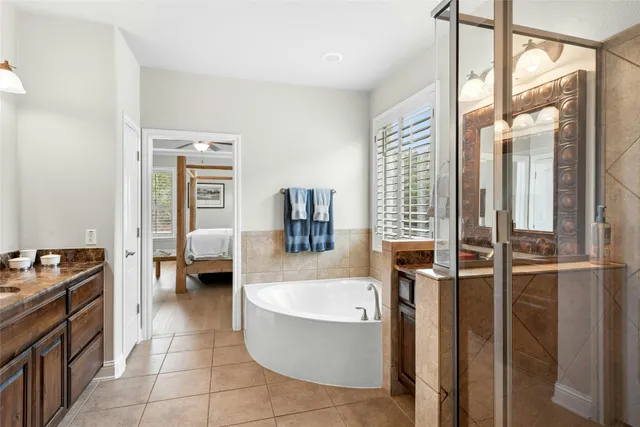 a bathroom with a tub a sink and a mirror