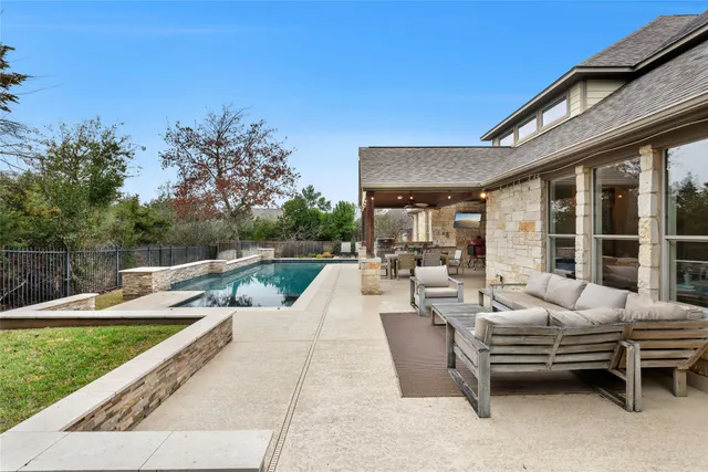 a view of swimming pool with outdoor seating and plants