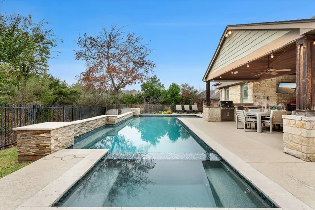 a view of swimming pool with a lounge chair