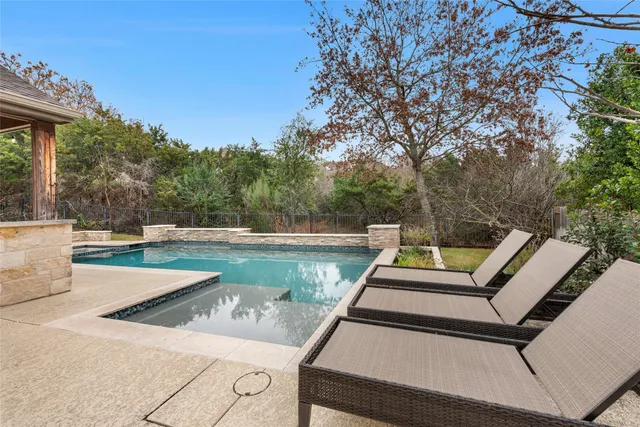 a view of a patio with chairs next to a yard