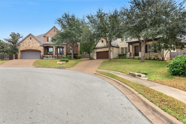 a yellow house with trees in front of it