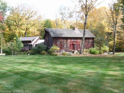 20 Ore Mine Road Salisbury, CT 06039 - Photo 1 of 1 a front view of a house with a garden and trees