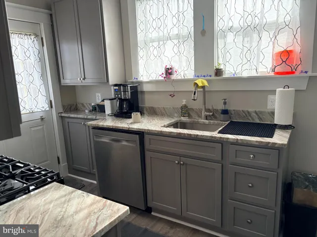 a kitchen with a sink and cabinets
