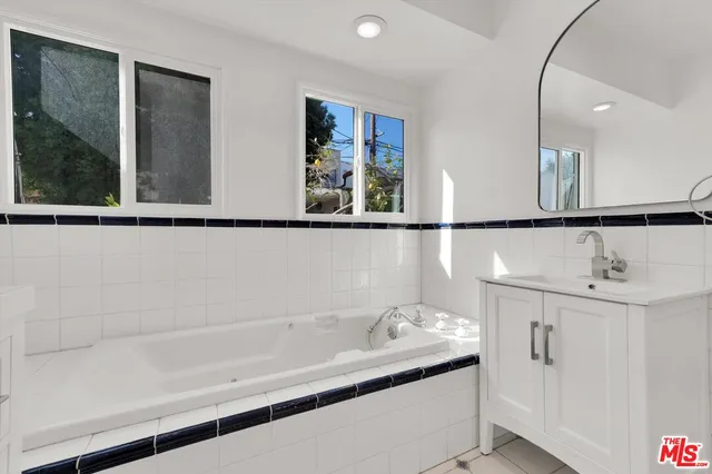 a bathroom with a bathtub and a window
