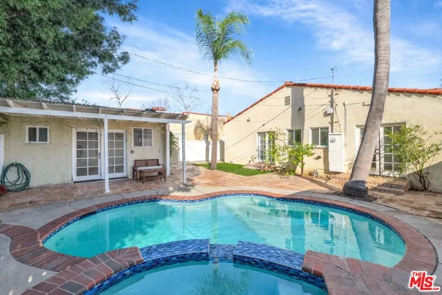 a view of backyard with swimming pool