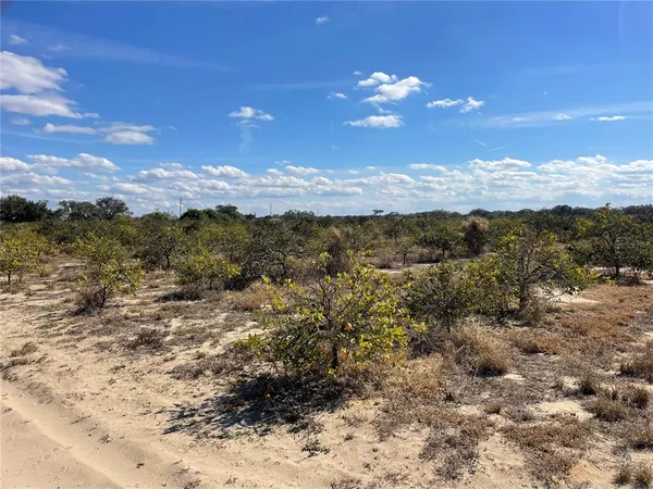 a view of a workspace with wooden floor and outdoor space