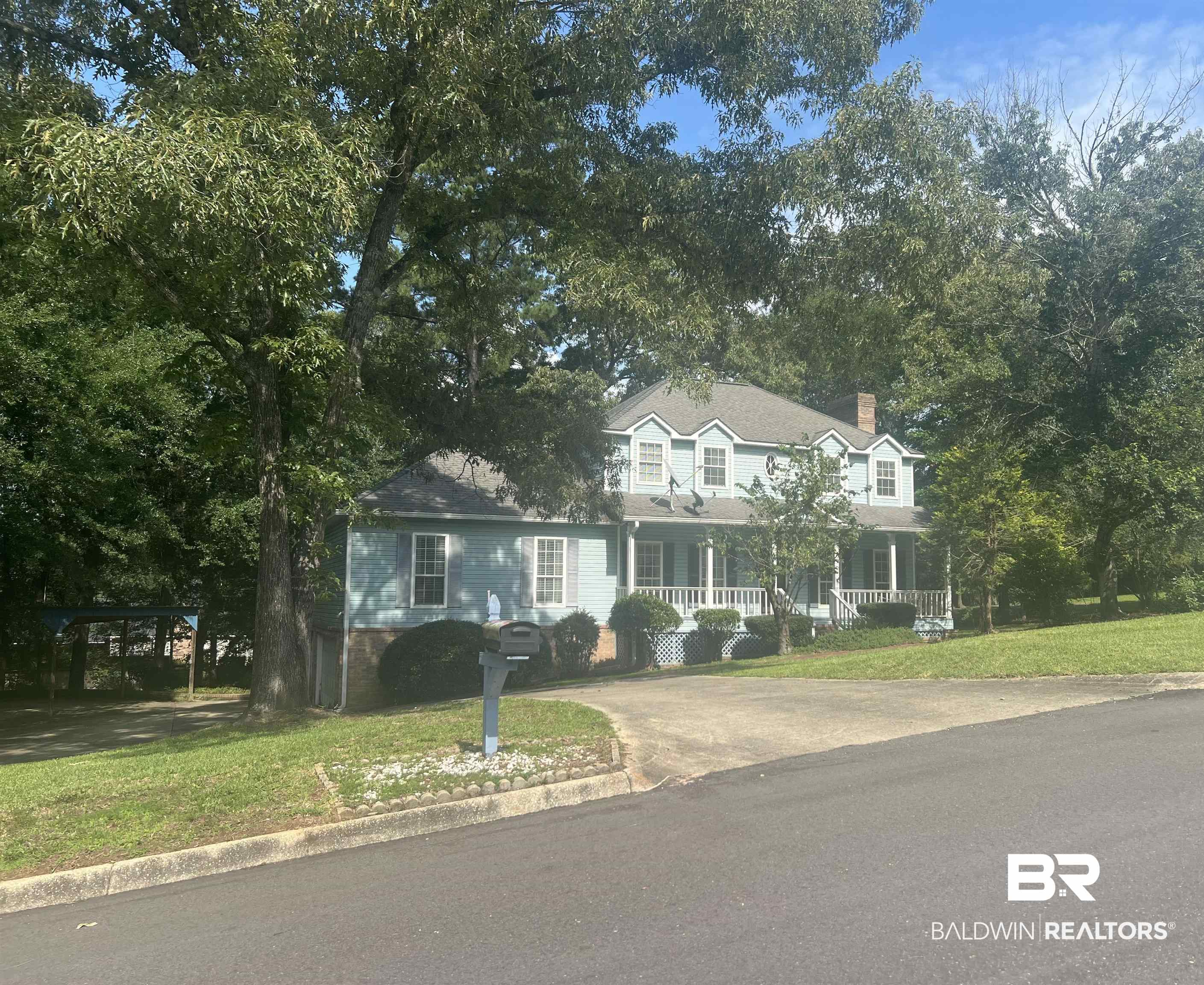 295 Norwood Road Monroeville, AL 36460 - Photo 1 of 32 Colonial house with covered porch, a front yard, a chimney, and driveway