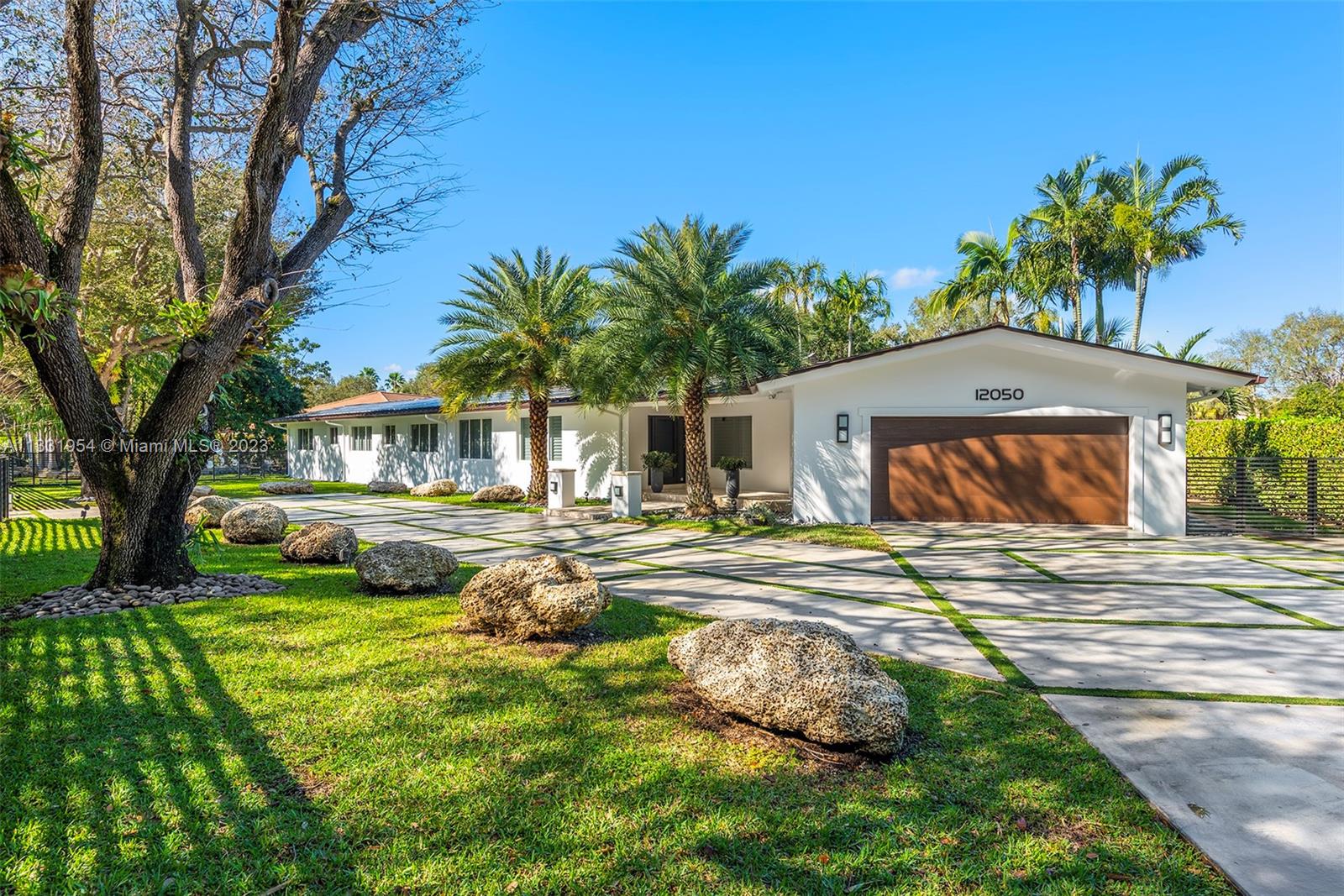 a house view with a sitting space garden and patio
