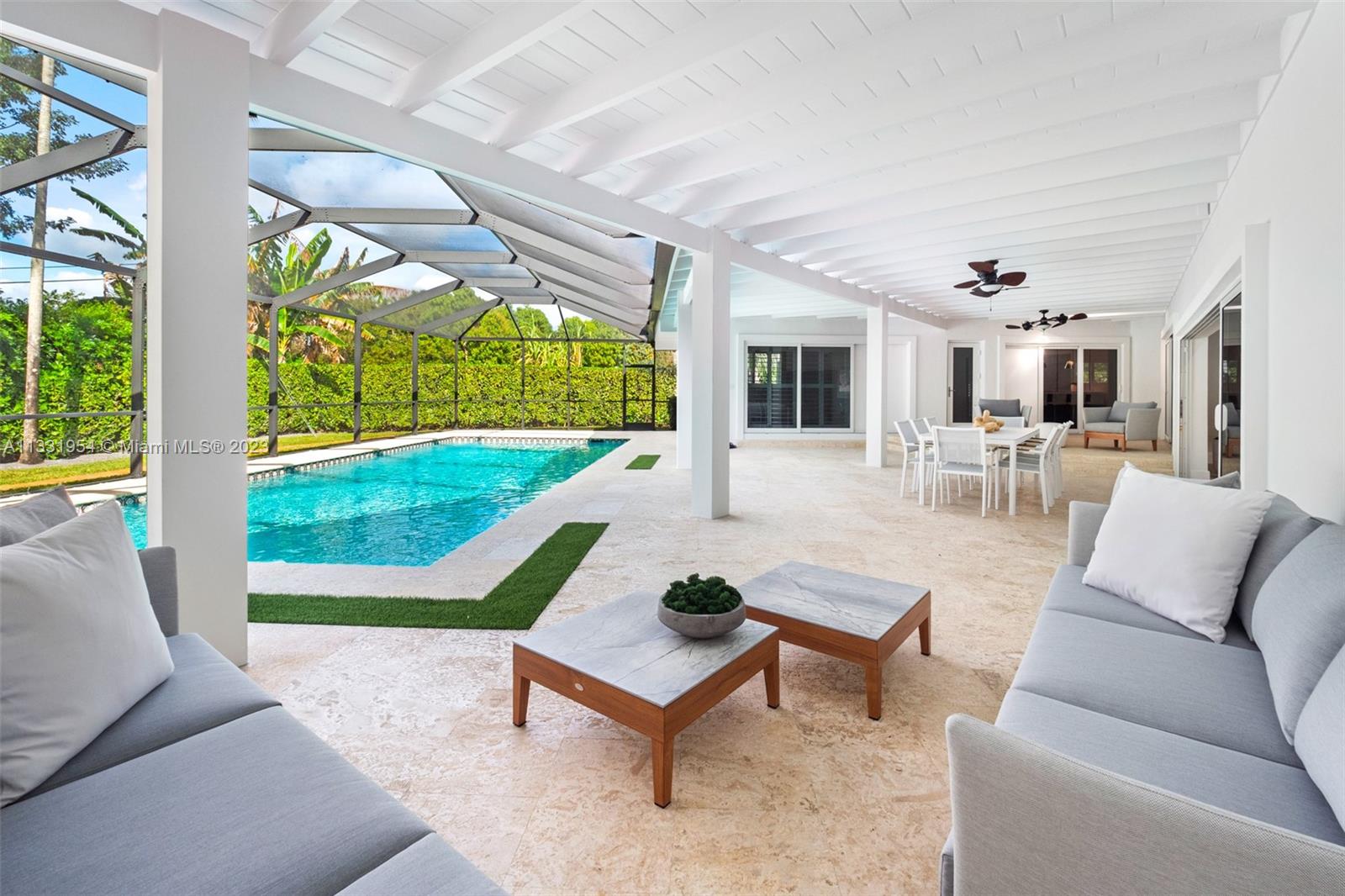 12050 Moss Ranch Road Pinecrest, FL 33156 - Photo 16 of 45 a living room with patio furniture and a yard