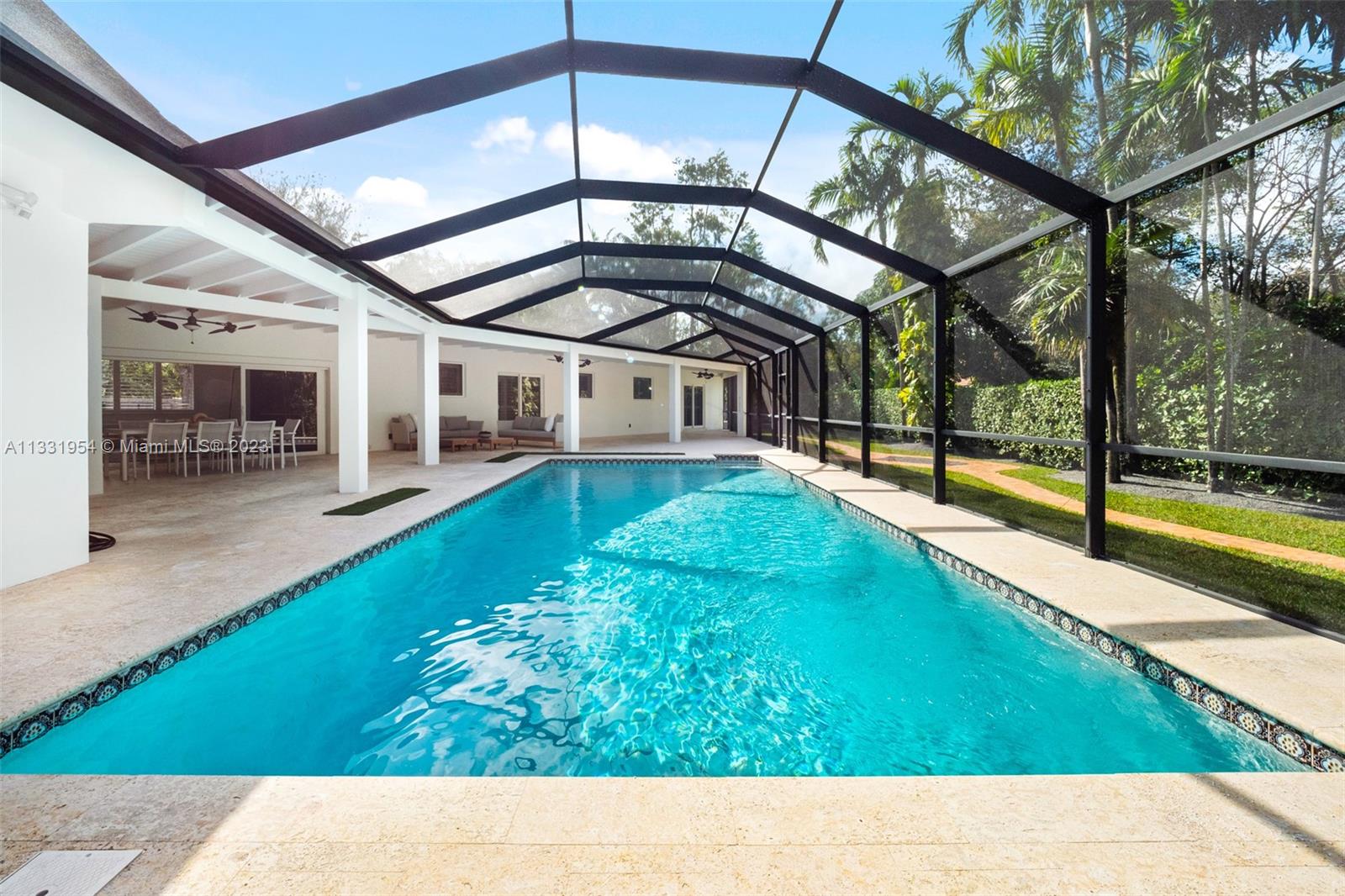 12050 Moss Ranch Road Pinecrest, FL 33156 - Photo 17 of 45 a view of an house with a swimming pool