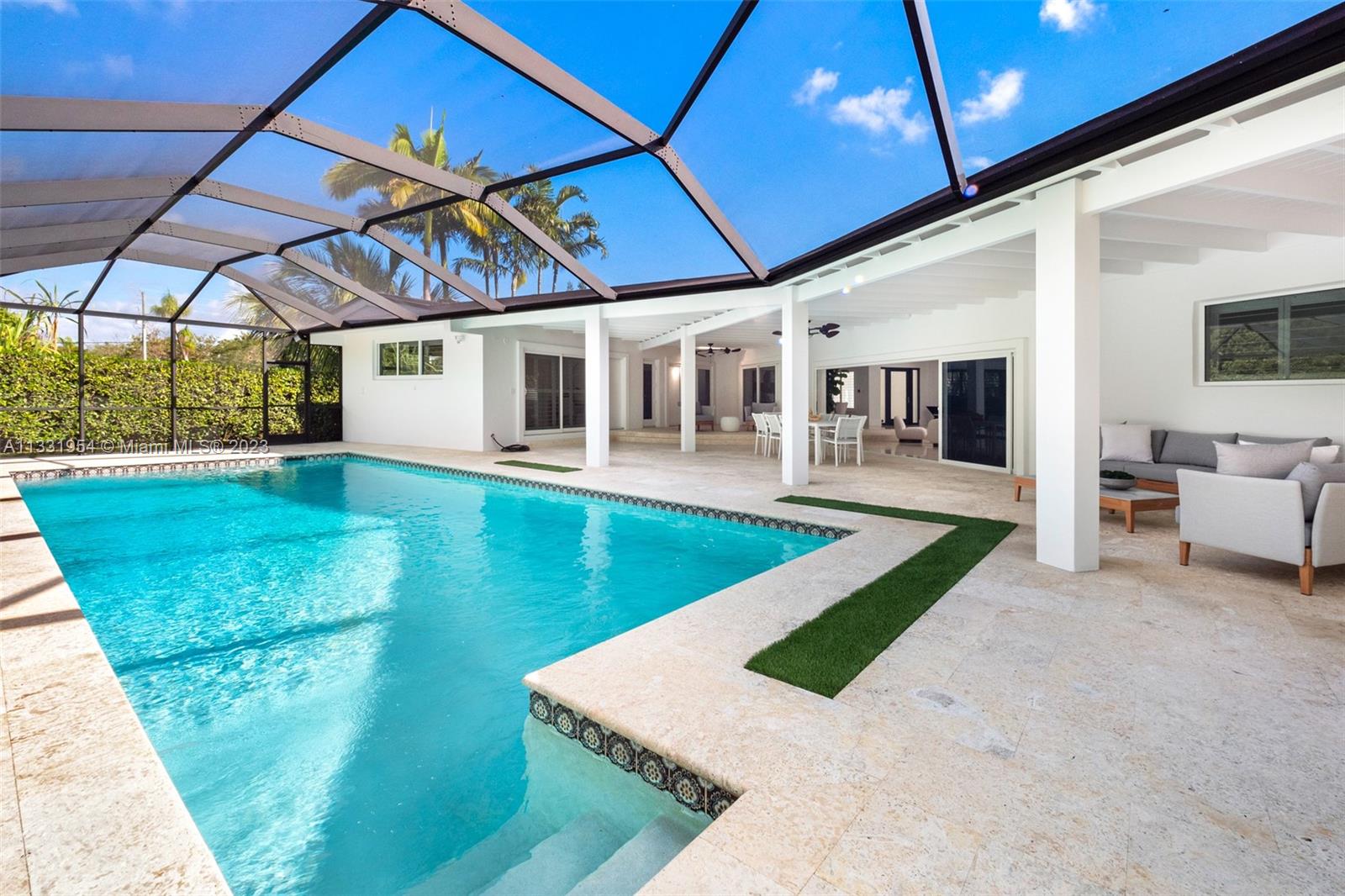 12050 Moss Ranch Road Pinecrest, FL 33156 - Photo 18 of 45 a view of a house with porch and a backyard