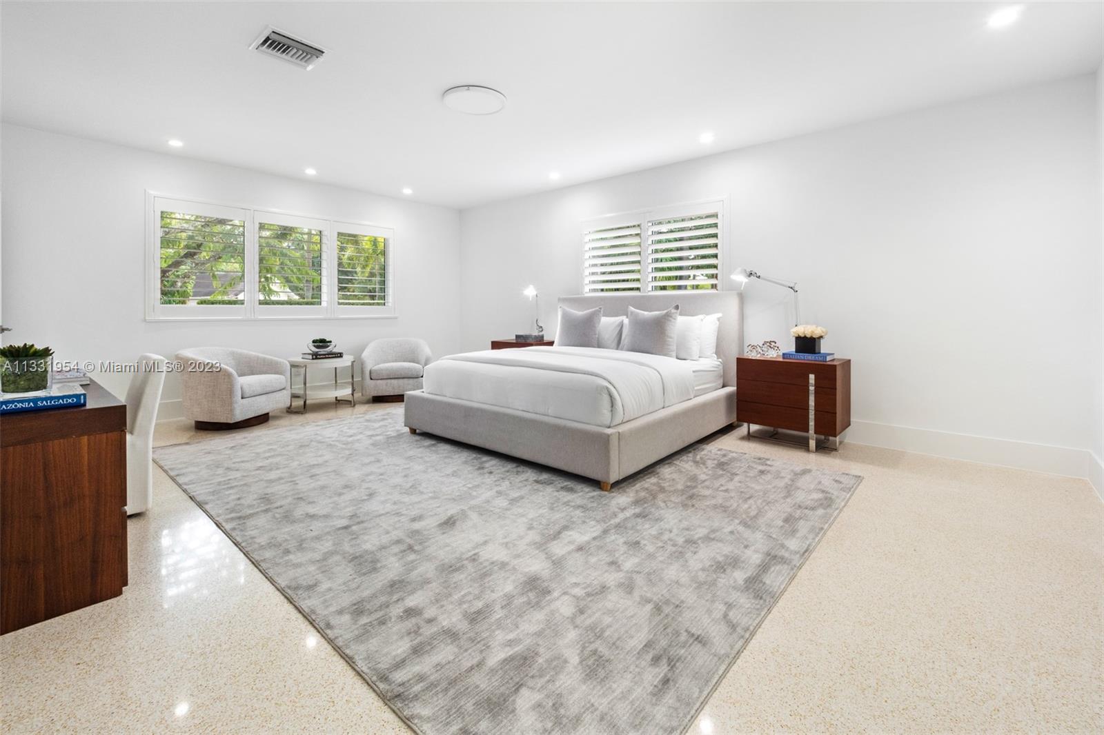 12050 Moss Ranch Road Pinecrest, FL 33156 - Photo 19 of 45 a spacious bedroom with a bed and window