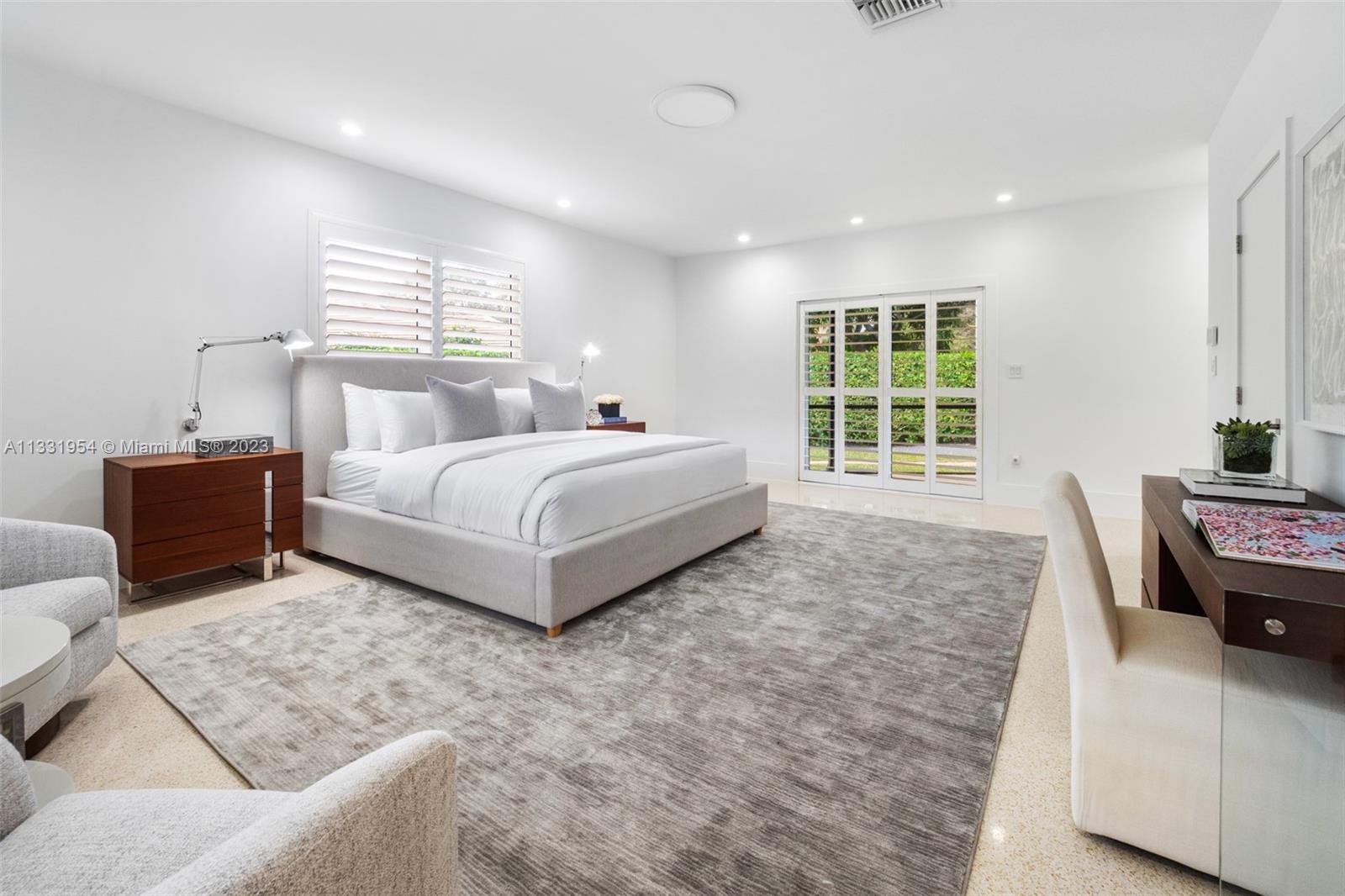 12050 Moss Ranch Road Pinecrest, FL 33156 - Photo 20 of 45 a spacious bedroom with a bed and wooden floor