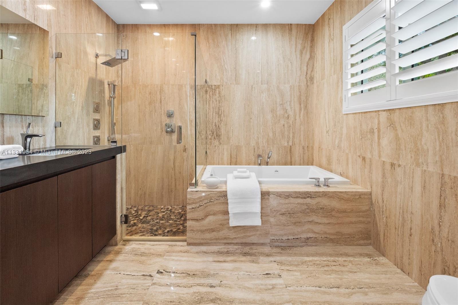 12050 Moss Ranch Road Pinecrest, FL 33156 - Photo 21 of 45 a bathroom with a granite countertop sink and a mirror