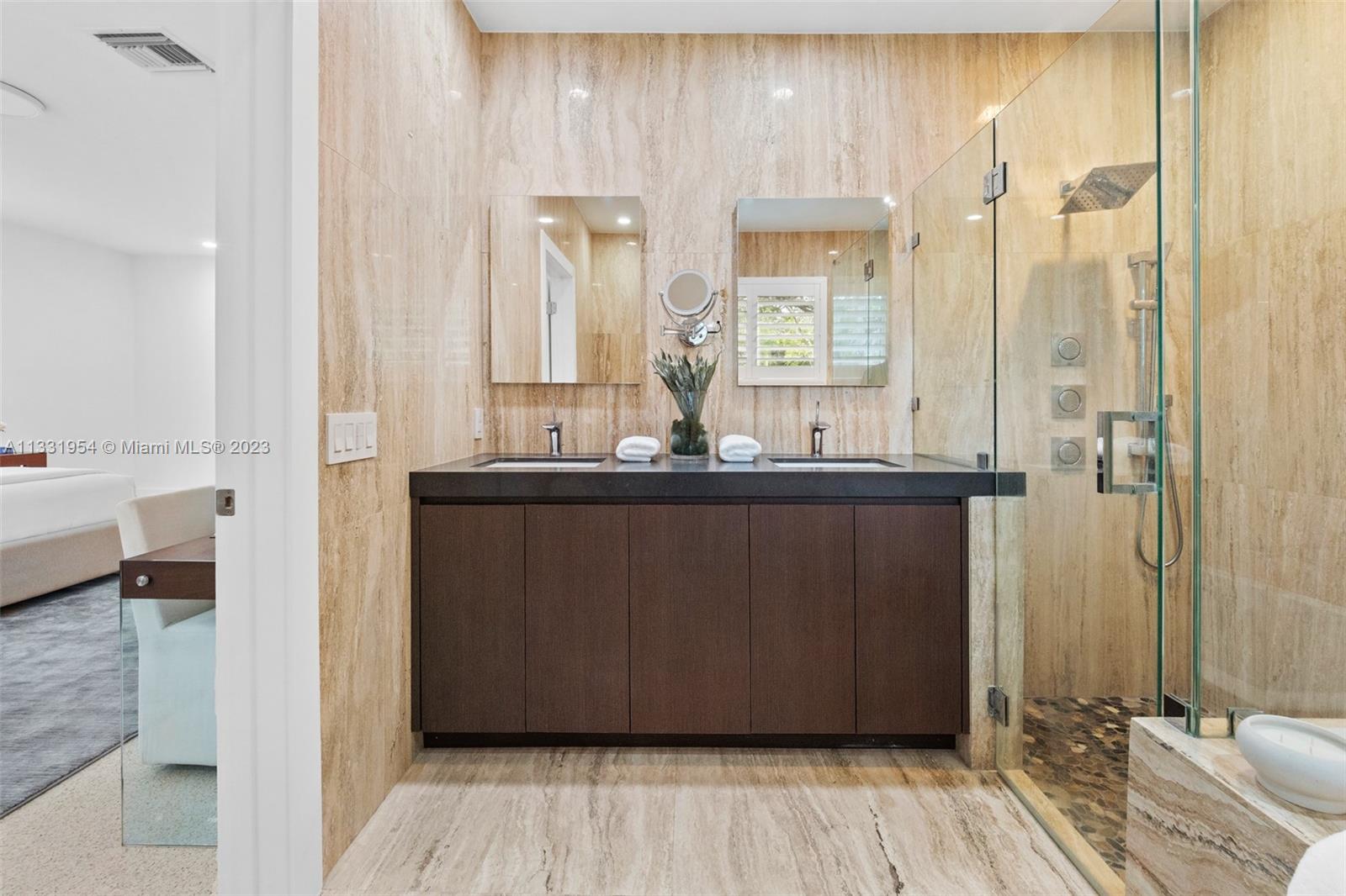12050 Moss Ranch Road Pinecrest, FL 33156 - Photo 22 of 45 a bathroom with a double vanity sink and a mirror