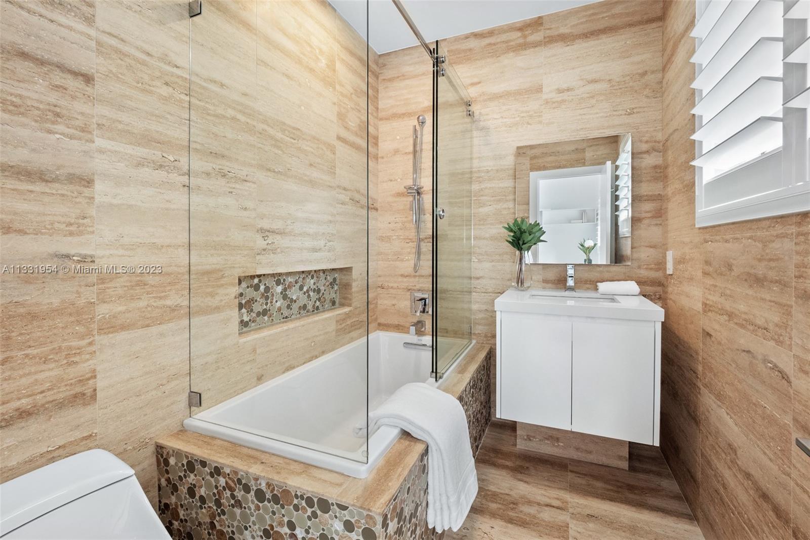 12050 Moss Ranch Road Pinecrest, FL 33156 - Photo 27 of 45 a bathroom with a sink a toilet and shower