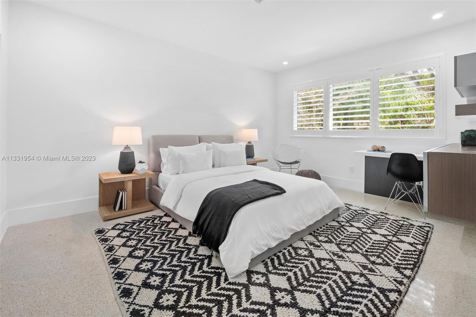 12050 Moss Ranch Road Pinecrest, FL 33156 - Photo 28 of 45 a bedroom with a bed and wooden floor