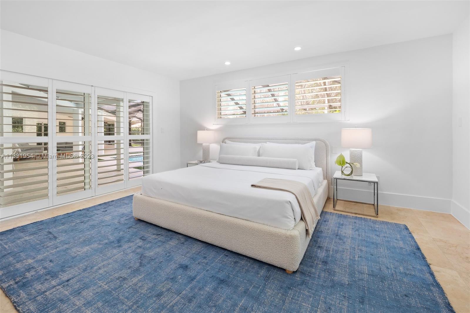 12050 Moss Ranch Road Pinecrest, FL 33156 - Photo 30 of 45 a bedroom with a large bed and a window