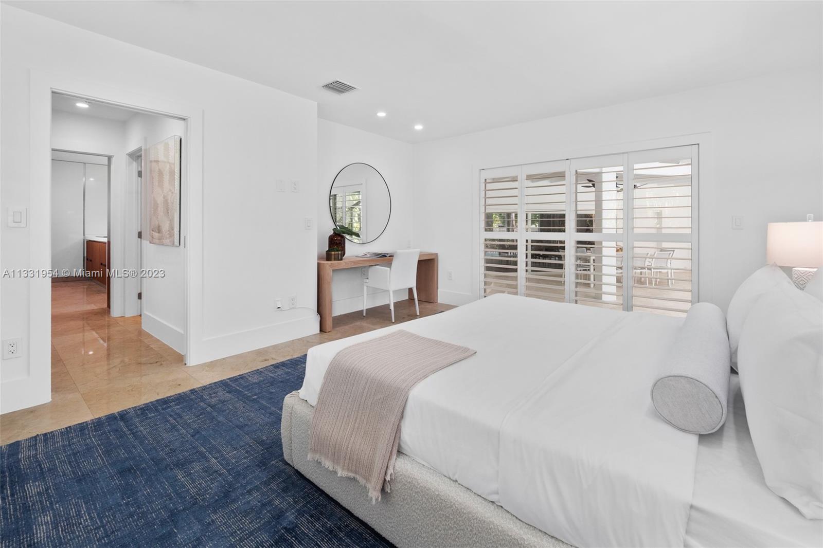 12050 Moss Ranch Road Pinecrest, FL 33156 - Photo 31 of 45 a bedroom with a bed and a large window