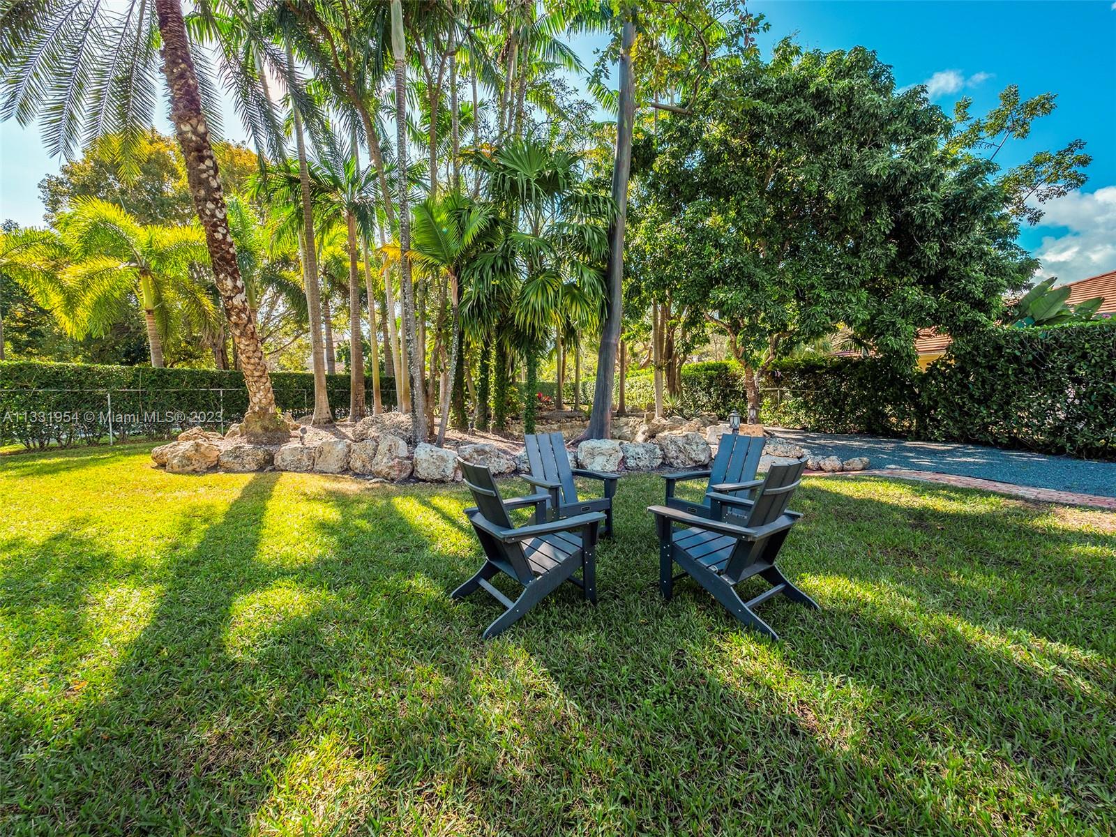 12050 Moss Ranch Road Pinecrest, FL 33156 - Photo 36 of 45 a view of swimming pool with outdoor seating and garden