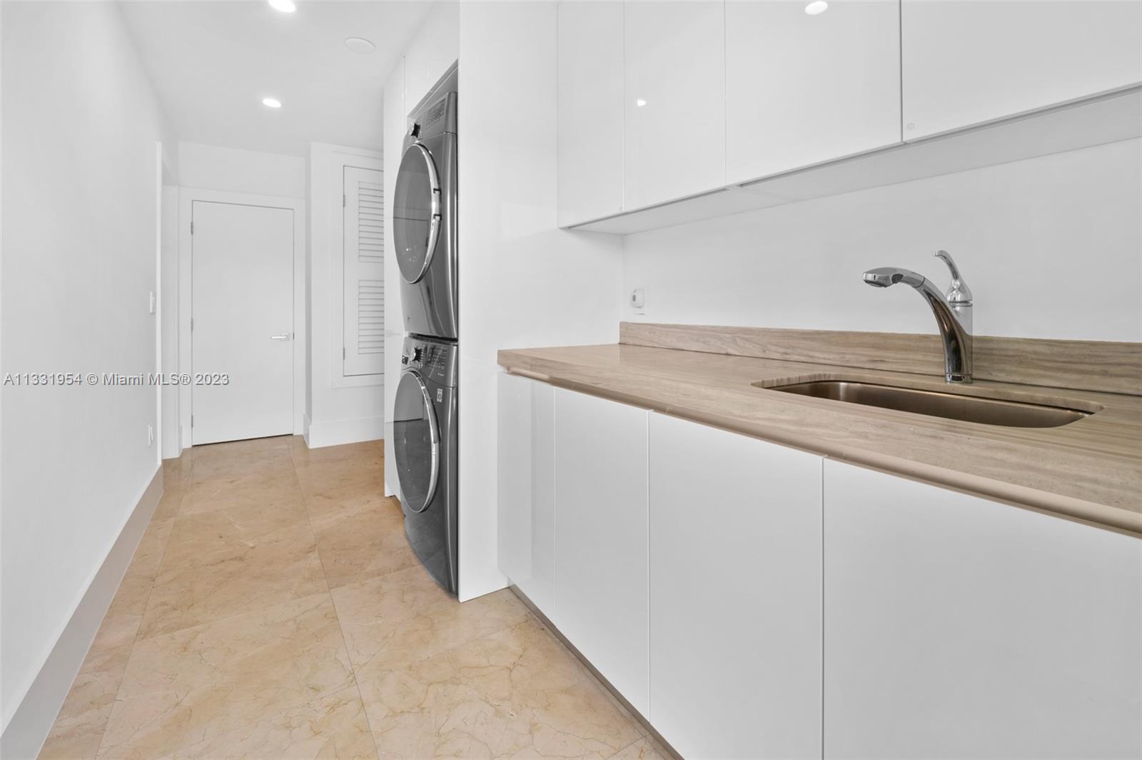 12050 Moss Ranch Road Pinecrest, FL 33156 - Photo 39 of 45 a kitchen with a sink and refrigerator