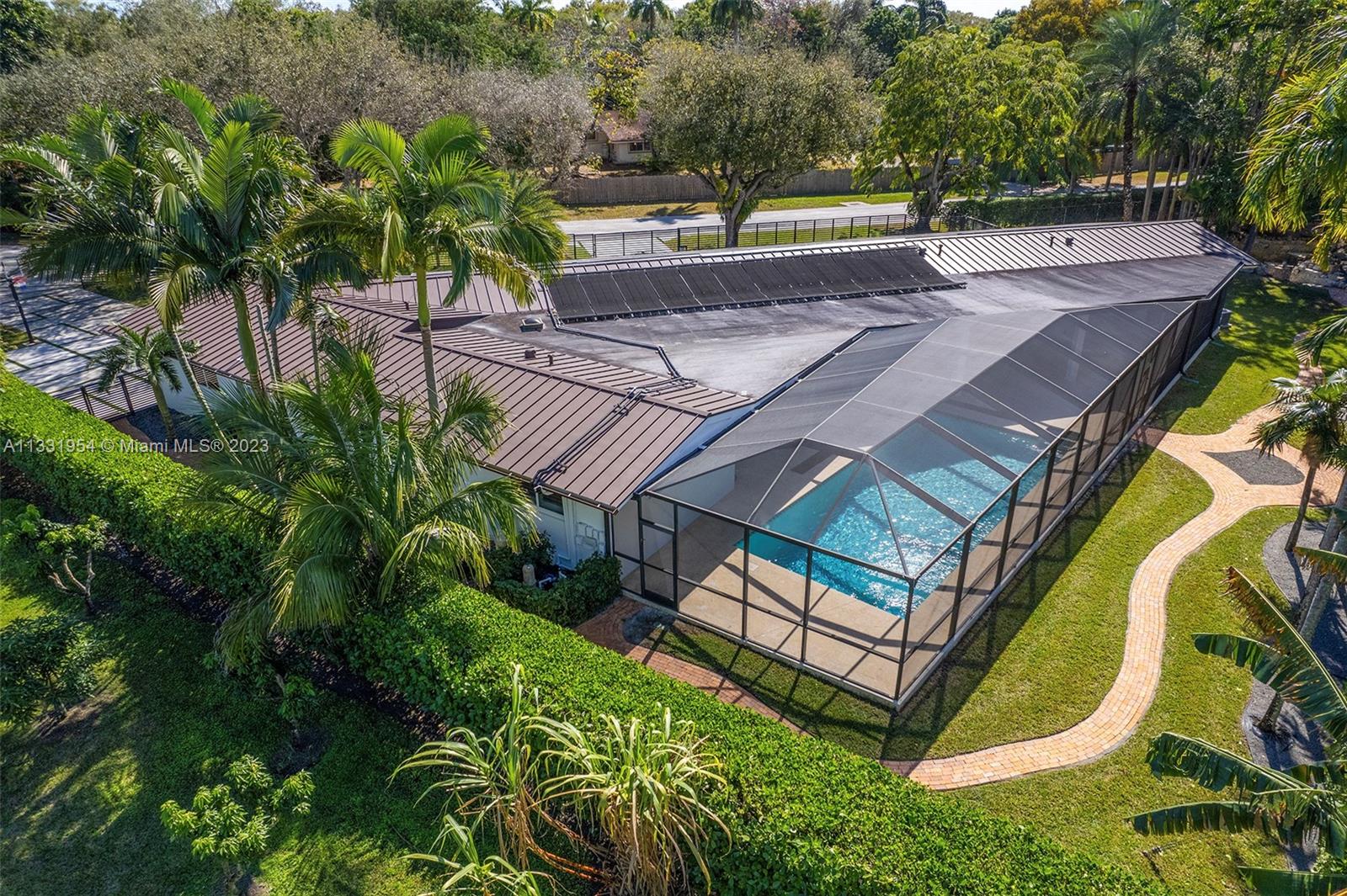 12050 Moss Ranch Road Pinecrest, FL 33156 - Photo 4 of 45 an aerial view of a house with swimming pool