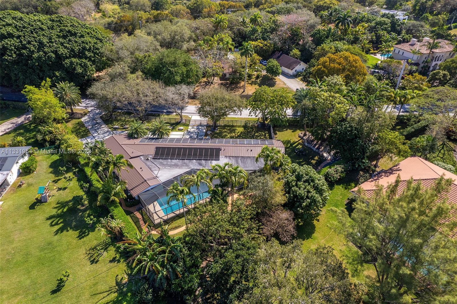 12050 Moss Ranch Road Pinecrest, FL 33156 - Photo 43 of 45 an aerial view of a house with a yard