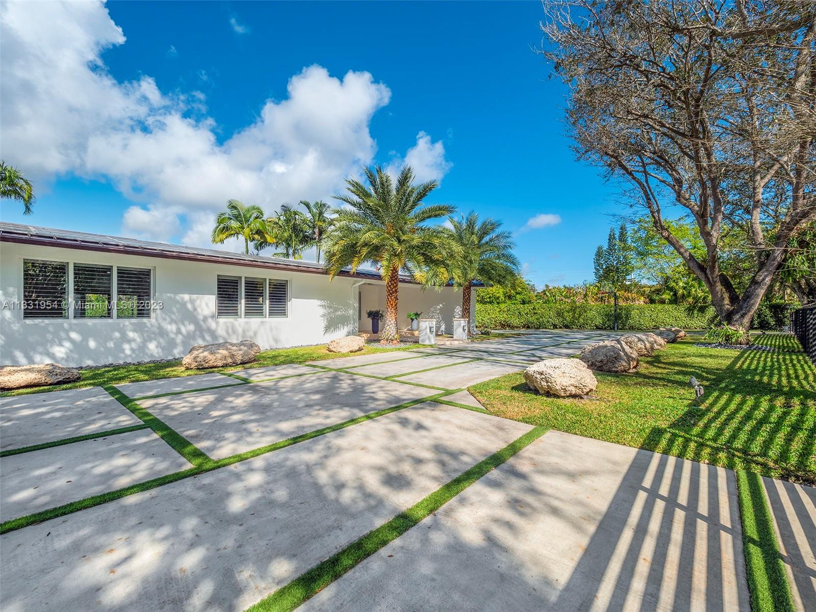 12050 Moss Ranch Road Pinecrest, FL 33156 - Photo 44 of 45 a view of a house with backyard and sitting area